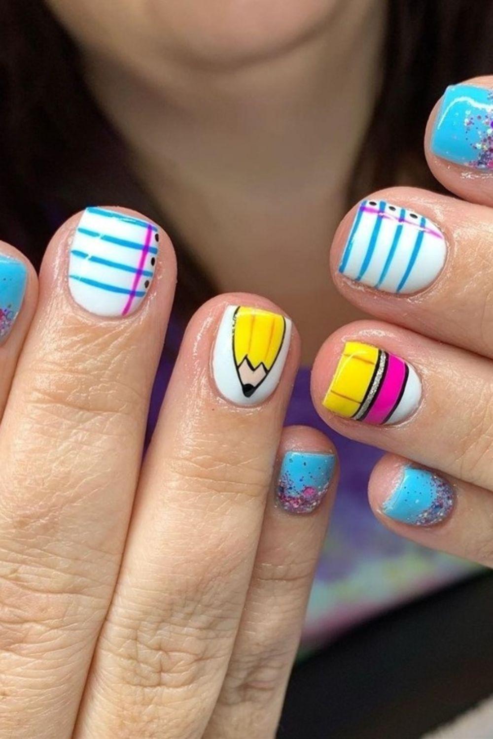 Blue notebook and pencil manicure